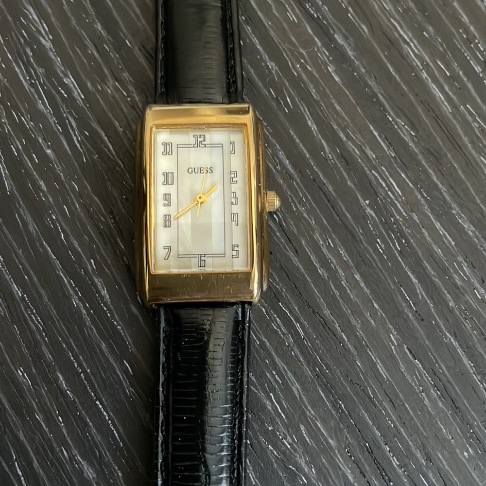 Guess watch. Mother of pearl face. Black band. Never been worn. Needs battery